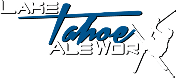 Logo reading "Lake Tahoe Ale Wor" with stylized blue script for "Tahoe." A white silhouette of a skier, evoking Nevada skiing, is on the right side, partially obscuring some letters. Mt. Rose Ski Tahoe