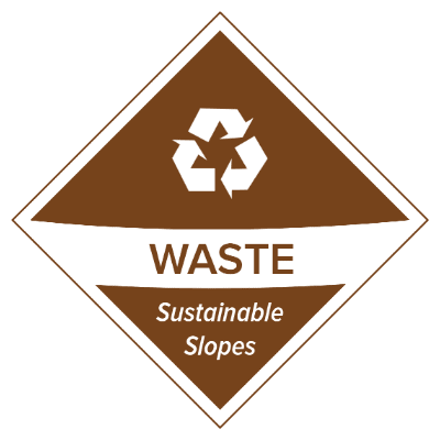 Brown diamond-shaped sign with a white recycling symbol above the word "WASTE" and the phrase "Sustainable Slopes," promoting sustainability on the mountain. Mt. Rose Ski Tahoe